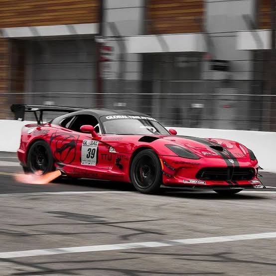 Red sports car shooting flames